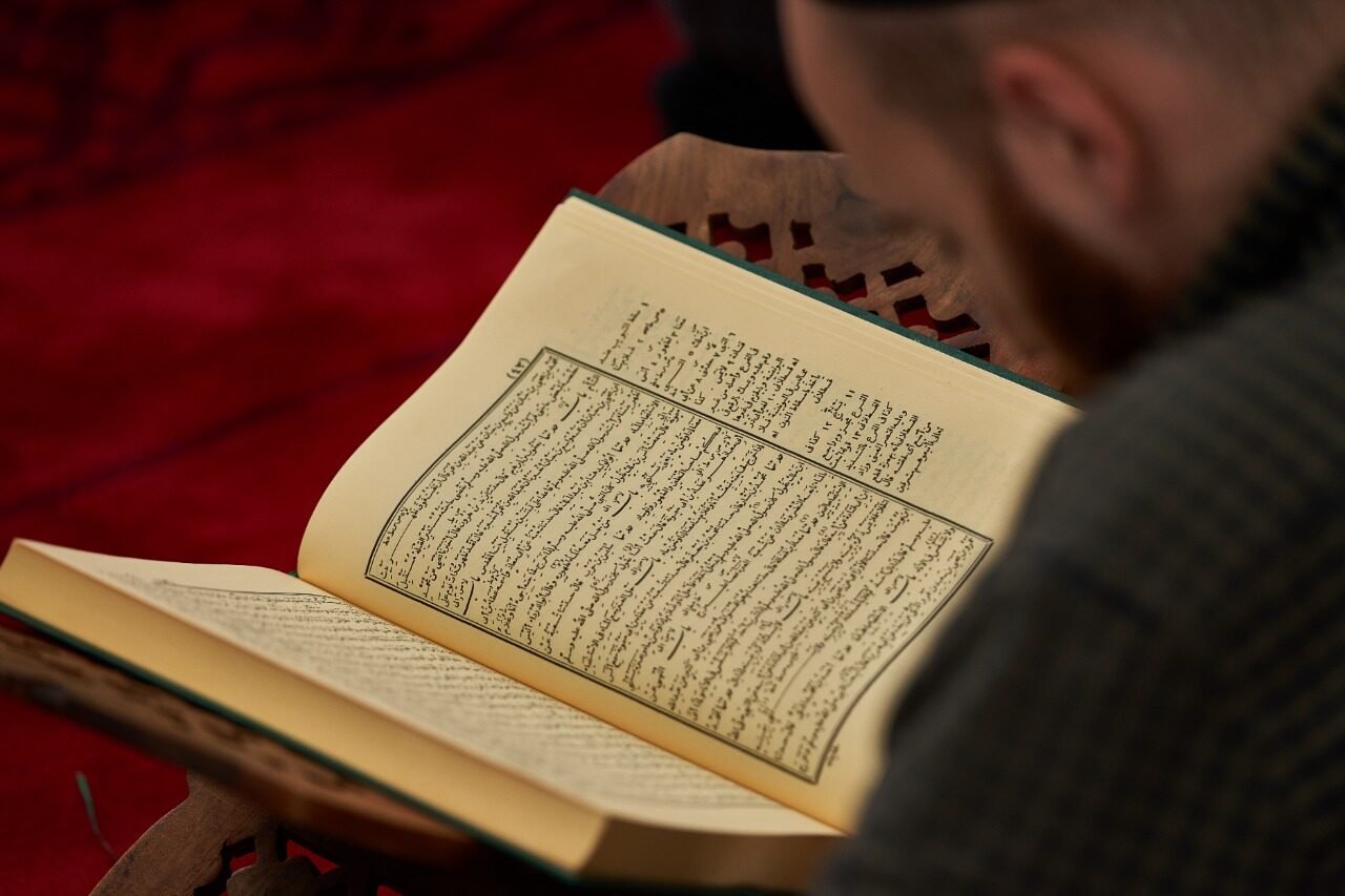 An open volume of Sahih Muslim being read